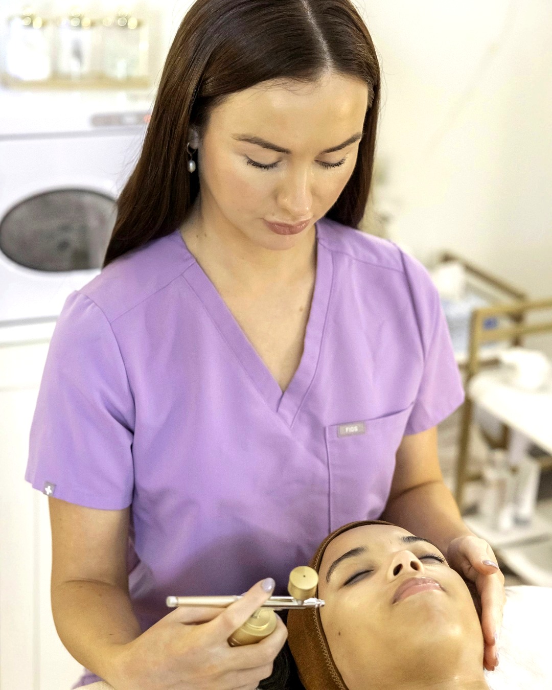 Roisin performing a facial treatment